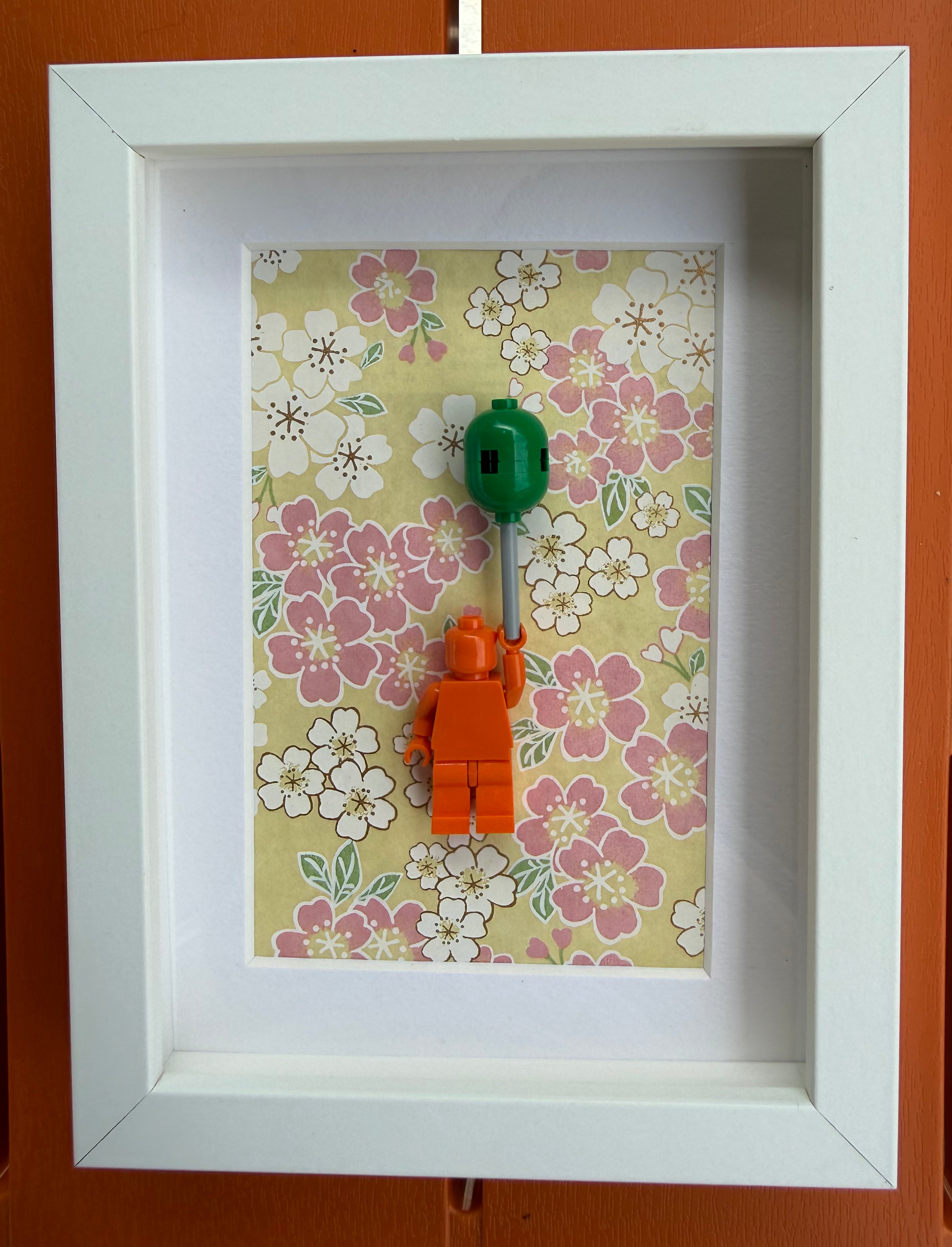 FRAMED ORANGE BRICK FIGURE WITH BALLOON