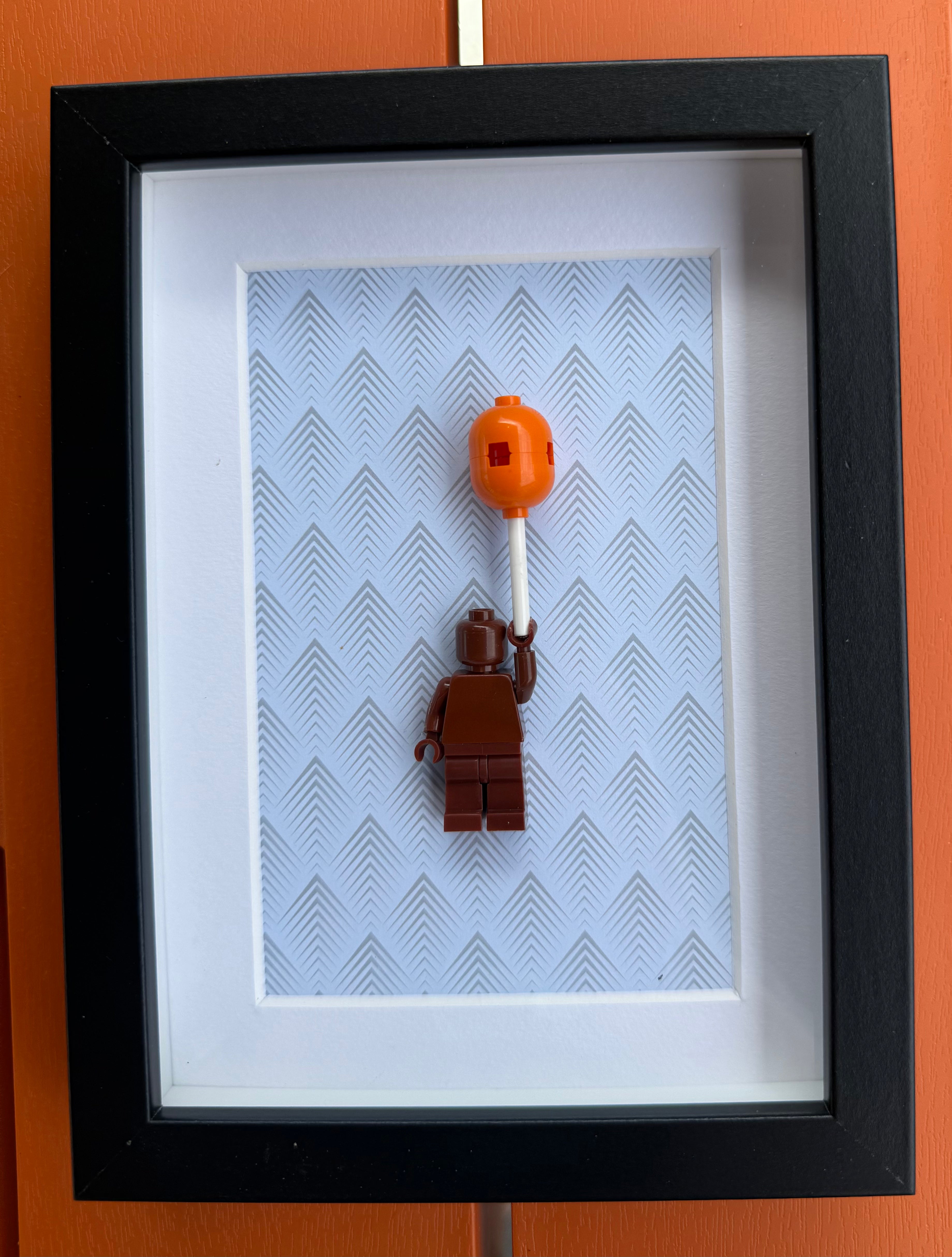 FRAMED BROWN BRICK FIGURE WITH BALLOON