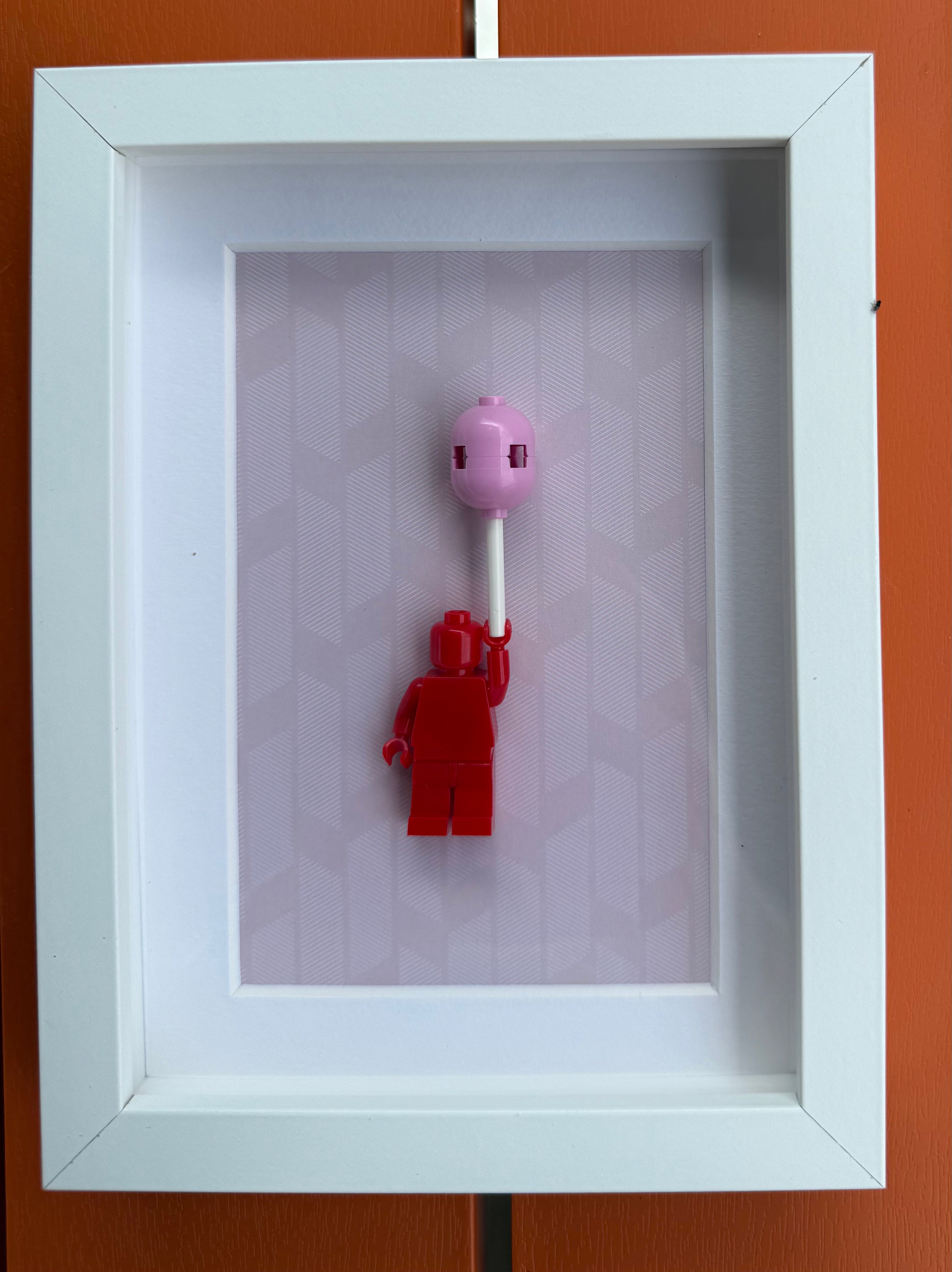 FRAMED RED BRICK FIGURE WITH BALLOON