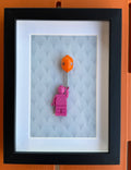 FRAMED PINK BRICK FIGURE WITH BALLOON