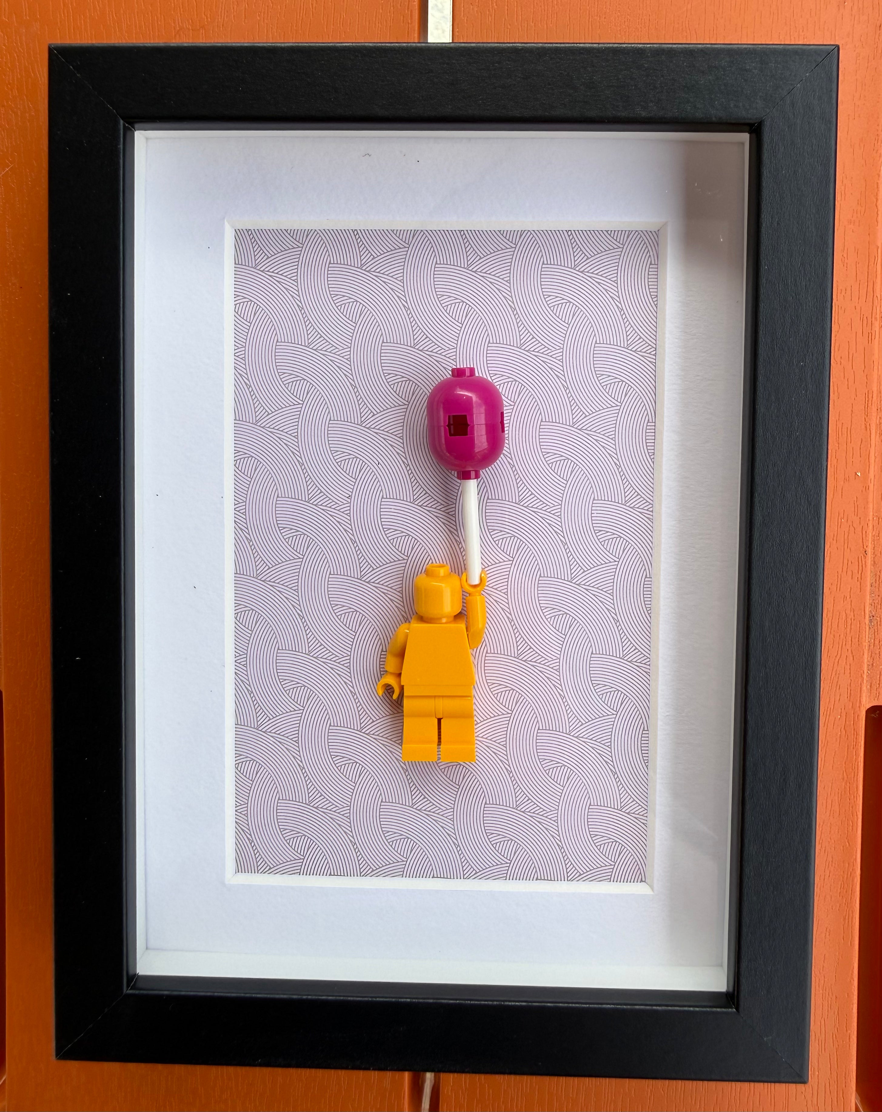 FRAMED YELLOW BRICK FIGURE WITH BALLOON