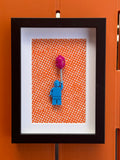 FRAMED BLUE BRICK FIGURE WITH BALLOON