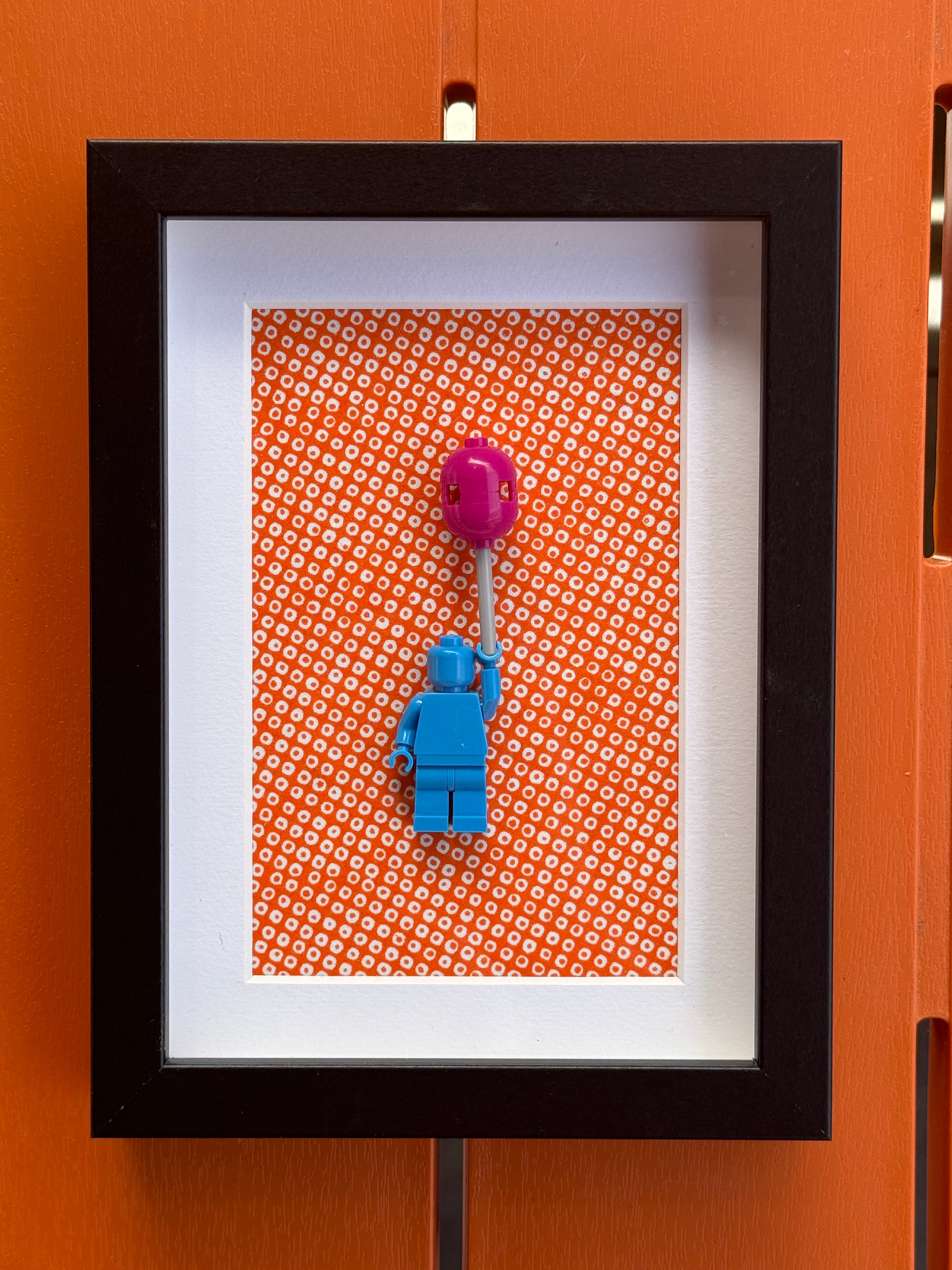 FRAMED BLUE BRICK FIGURE WITH BALLOON